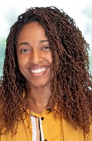 Headshot of Owner and Registered Dietitian of Geelo Wellness. Kanisha Neal is smiling and looking directly at the camera. 